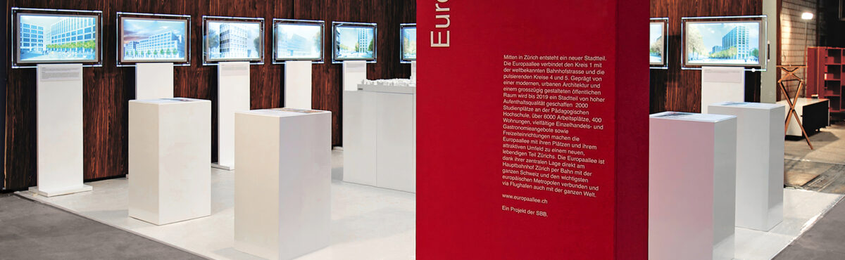 standkonzept mit led bildrahmen und weissen kubischen theken